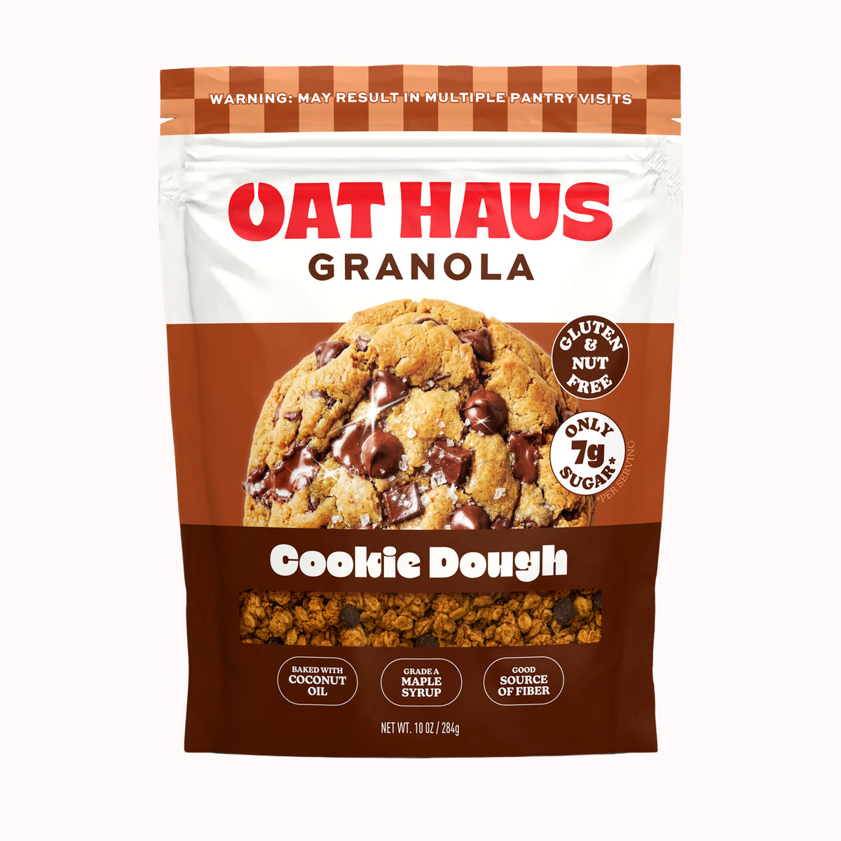 A stand-up pouch of Oat Haus Granola Cookie Dough, featuring a large image of chocolate chip cookie dough on the front, with white and brown packaging and red brand lettering.